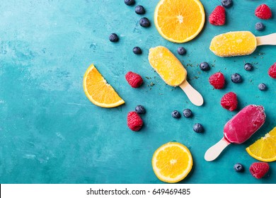 Home Made Ice Cream With Berries, Orange Over Blue Wooden Background. Top View