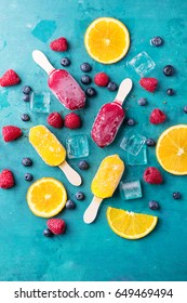 Home Made Ice Cream With Berries, Orange Over Blue Wooden Background. Top View