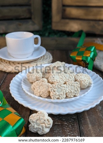 Home made of Malaysia traditional Coconut Cream Cookies or known as 'Kuih Bangkit' on the table. Famous delicacy for Hari Raya. Kuih bangkit is popular during Eid celebration