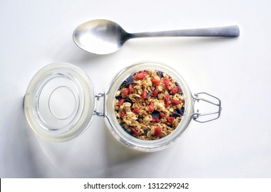 Home made peach pudding with granola, chocolate pieces, goji berries and chia seeds - Powered by Shutterstock