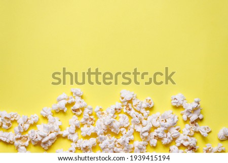 Similar – woman with popcorn in hand on yellow background. Copyspace