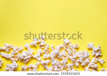 Similar – woman with popcorn in hand on yellow background. Copyspace