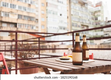 Home Made Preparation Of An Aperitif Outside The Balcony. Two Beers On A Wooden Table For Business People After Work. Some Peanuts In The Bowl. Lisbon, Portugal