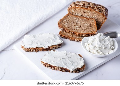 Home Made Rye Bread On A Wooden Cutting Board With Curd Cheese And Ricotta