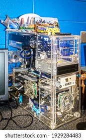 Home Made See Through Computer Sitting On Lab Counter With Google Eyeballs And Stuff Piled On Top