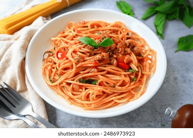 Home made Spaghetti with Tomato Sauce and minced pork in a white plate on gray cement background - Powered by Shutterstock