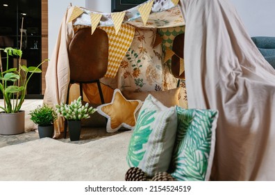 Home Made Tent Made With Chairs And Bed Sheets In The Living Room