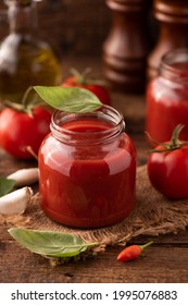 Home Made Tomato Sauce In A Jar On A Wooden Table