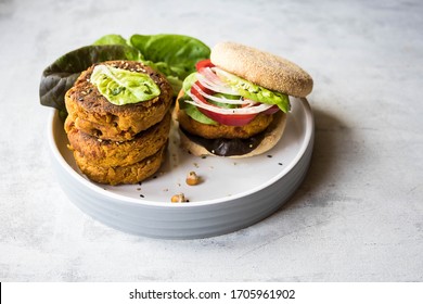 Home Made Vegan Burger With Carrot And Chickpea Cutlet , Lettuce And Micro Greens