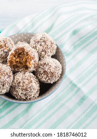 Home Made Vegan Energy Protein Balls With Coconut Flakes, Almond Butter, Oats, Nuts, Dates, Dried Fruit, Flax And Hemp Seeds Served In Bowl On Turquoise Napkin