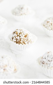 Home Made Vegan Energy Protein Balls With Coconut Flakes, Almond Butter, Oats, Nuts, Dates, Dried Fruit, Flax And Hemp Seeds Served On White Background.