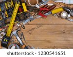 Home maintenance - An untidy workbench full of dusty old tools and screws with space for text.