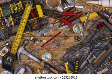 Home Maintenance - An Untidy Workbench Full Of Dusty Old Tools And Screws.