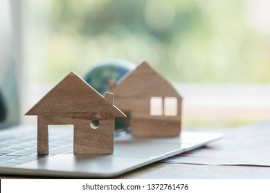 Home Model For Loan Real Estate To Buy New For Family Or Property Mortgage Investment Concept: Wooden House Models On Laptop Computer With Chart Report Documents,wealth Management For Agency Online.