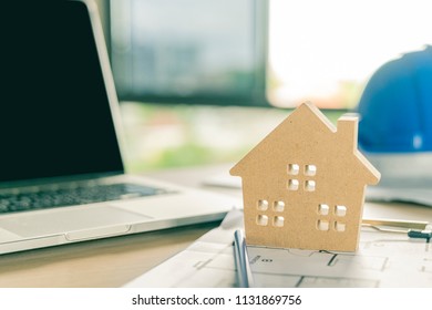 Home model on blueprint and tablet .architech concept.blueprint is fake only for stock photo
 - Shutterstock ID 1131869756