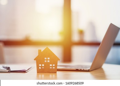 Home model put near Lease or Rental agreement document and laptop with copy space, real estate Business for buy , loan or investment concept - Shutterstock ID 1609268509