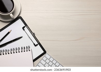 Home office. Coffee, computer keyboard and stationery on white wooden desk, flat lay. Space for text - Powered by Shutterstock