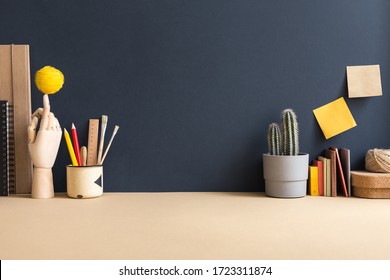 Home Office, Creative, Surreal Workspace With Cactus, Wooden Hand And Empty Blue Wall For Copy Space. Homeschooling Workplace. Creative Desk.