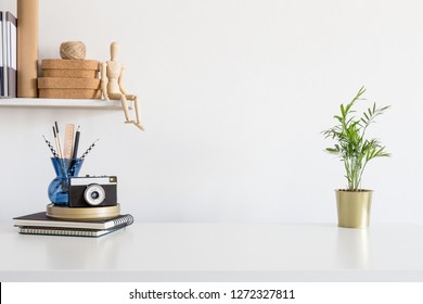 Home Office Desk With Cork Boxes, Stationery, Mannequin On A Shelf And White Wall For Mock Up Or Copy Space.