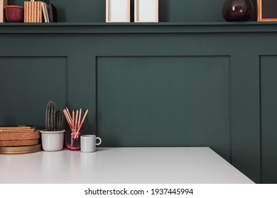 Home Office Desk In The Corner, Office Supplies, Mug With Tools, Notes, Books And Dark Green Wall. Homeschooling Concept. Trendy, Creative Workspace.