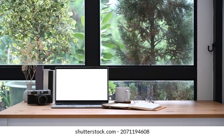 Home Office Desk With Laptop Computer, Coffee Cup And Books.