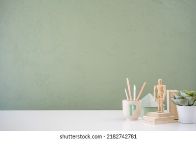 Home Office Desk Office Supplies, Mug, Boxes And Green Wall. Minimal Workspace.