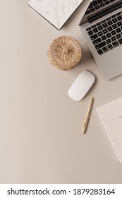 Home Office Desk Workspace With Laptop, Straw Casket On Neutral Background. Flat Lay, Top View Blog, Website, Social Media Concept.