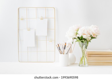 Home Office Desktop And Mood Board With Empty Card, White Peonies In A Vase, Office Supplies On A Light Background