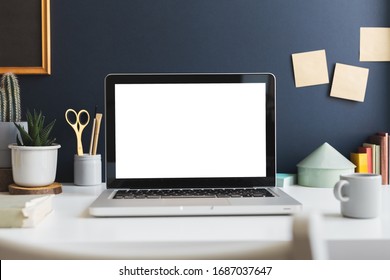 Home Office With Laptop Stationery, Cactus And Books Near Navy Blue Wall. Home Learning Concept. Trendy, Creative Desk.