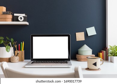 Home Office With Laptop Stationery, Cactus And Books Near Navy Blue Wall. Home Learning Concept. Trendy, Creative Desk.