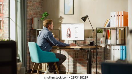 At Home Office: Man Using Desktop Computer, Online Shopping For Electronics, Wireless Hi-Fi Headphones. E-Commerce Concept Of Purchasing, Buying, Ordering Tech Devices On Website. Over Shoulder View