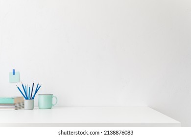 Home Office, Minimal Workspace. Desk With Office Supplies White Wall And Empty Product Space.
