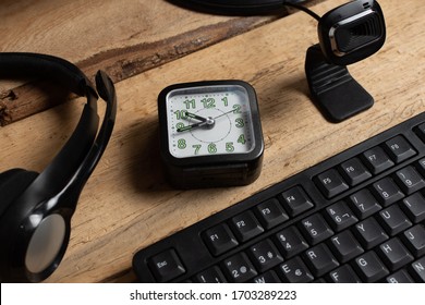 Home Office Theme: Close-up. Headband, Web Cam Microphone And Watch With Alarm. Online Business Hours Concept. Concept Of Keep To The Timetable. When Working Online From Home.