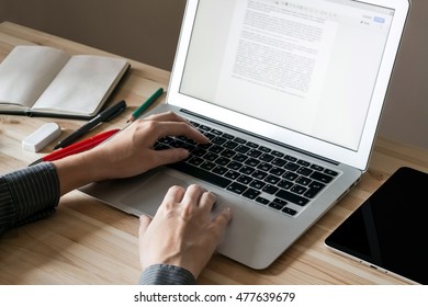 Home office workplace with laptop, tablet and notebook. Female hands working with computer. - Shutterstock ID 477639679