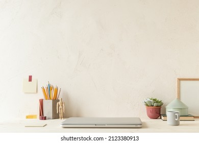 Home Office, Workspace With Close Laptop Computer, Pencil, Notepad, And Empty Wall For Copy Space Or Product Montage. Homeschooling Workplace. Wooden Desk Mockup.