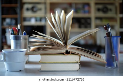 Home Office,education,business,concept With Open Book,coffee And Office Supplies, Close Up Shot With Shallow Depth Of Field.