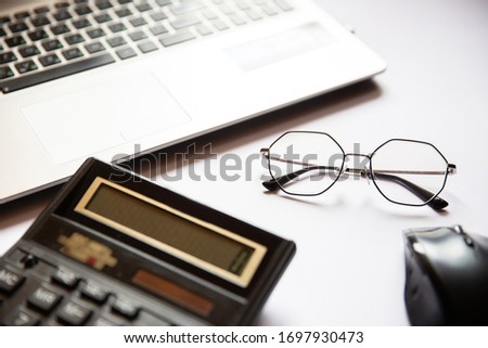 Home officestuff. Keyword, calculator, glasses, mouse for laptop
