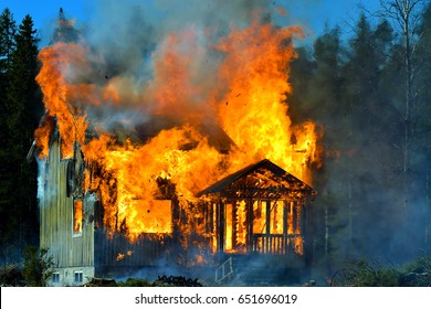 Home On Fire As The Flames Burst Through The Windows, Door And Roof Of The House