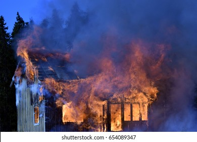 Home On Fire As The Flames Burst Through The Windows, Door Of The House. 