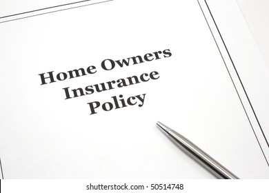 A Home Owners Insurance Policy With A Pen Ready To Be Signed.