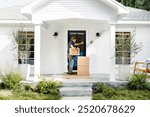 Home package delivery man knocking the front door. Delivery man holding package box in front of the door house. Delivery service at home. Home package delivery man on the front door. 