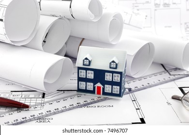 home plans and ruler pen and a miniature house - Shutterstock ID 7496707