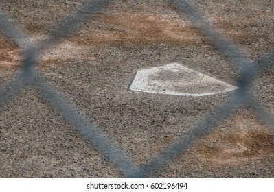 Home Plate In Baseball Diamond Through Fence