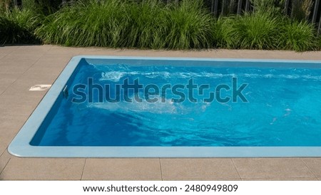 In the home pool, the counter-current system is turned on, making it an excellent place to swim in the backyard