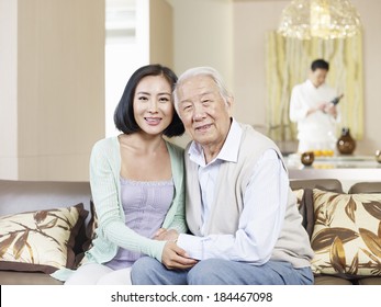 Home Portrait Of Asian Father And Daughter