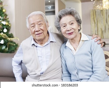 Home Portrait Of Senior Asian Couple Smiling