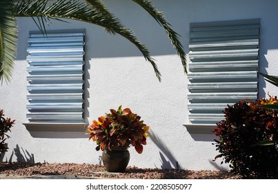 Home Prepares For Hurricane By Putting Up Storm Shutters.                       