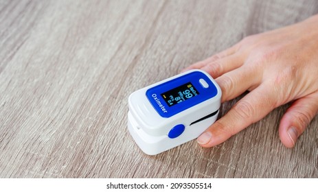 Home Pulse Oximeter, Patient Measuring The Blood Oxygen With Oximeter