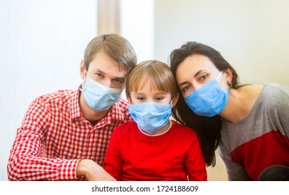 Home Quarantine. Coronavirus Epidemic. Parents And Kid Wearing A Surgical Mask. Coronavirus Outbreak. New Real Life. Young Family In Safety Medical Masks. Prevention Coronavirus. Stay At Home.