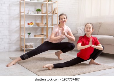 Home Quarantine Workout. Positive Mom And Her Happy Teen Daughter Stretching Their Legs In Living Room, Blank Space. Mother And Her Child Exercising, Doing Yoga Or Pilates Together Indoors